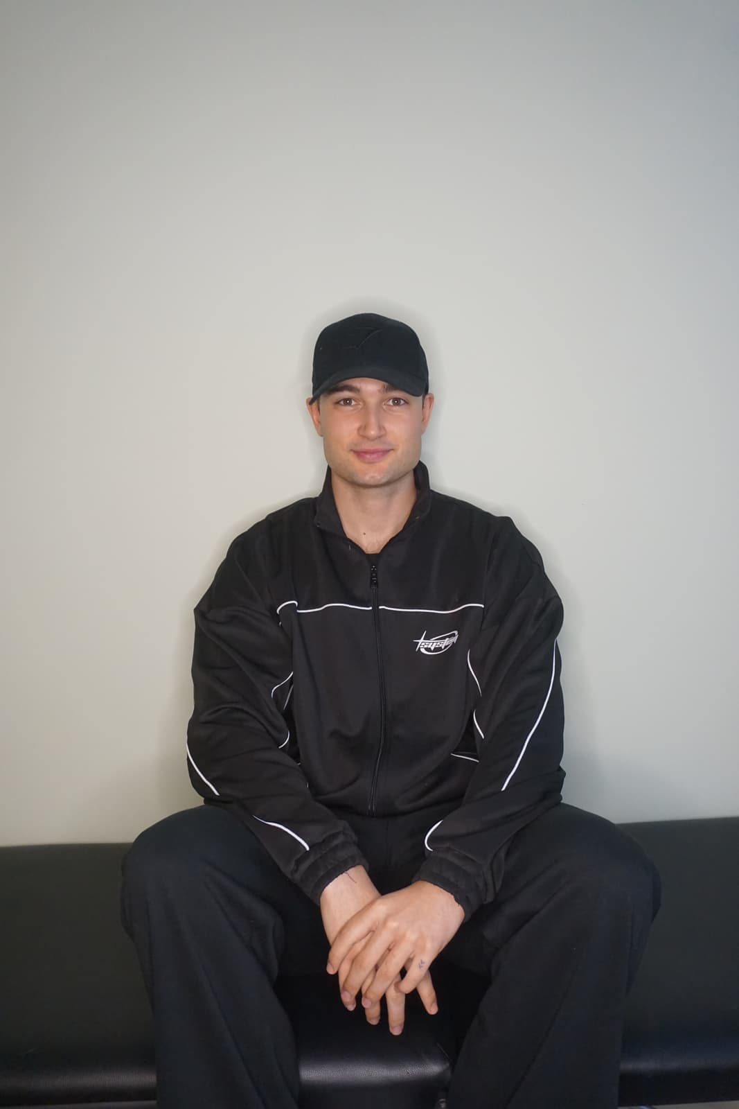 Man in a black long sleeve shirt wearing black framed eyeglasses