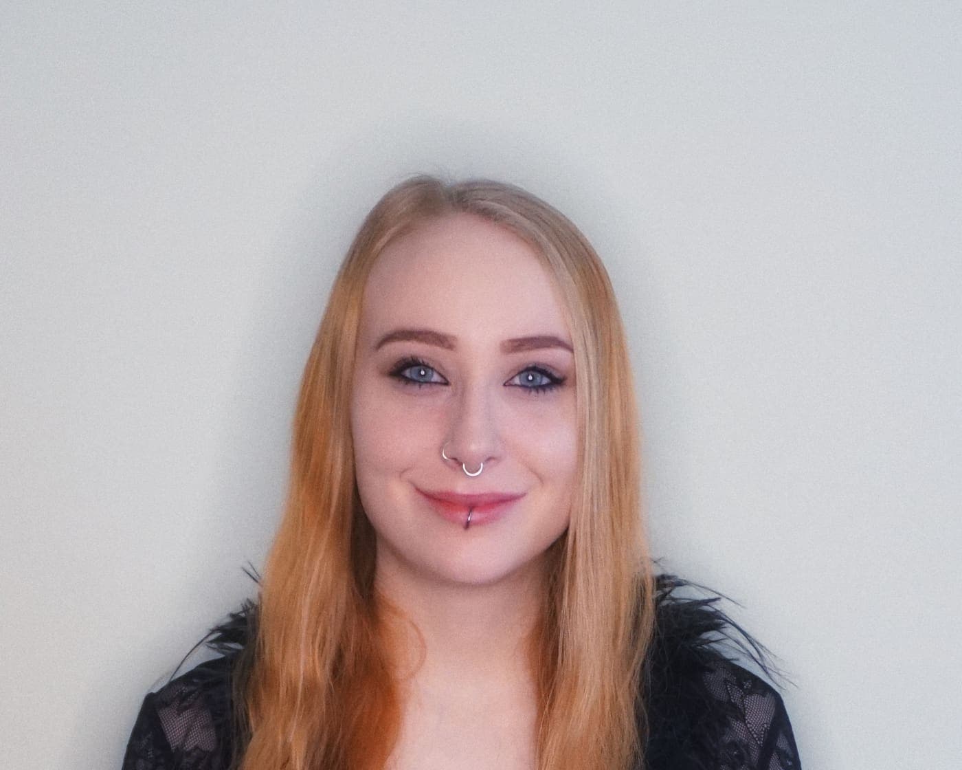 Smiling woman posing in a bright studio